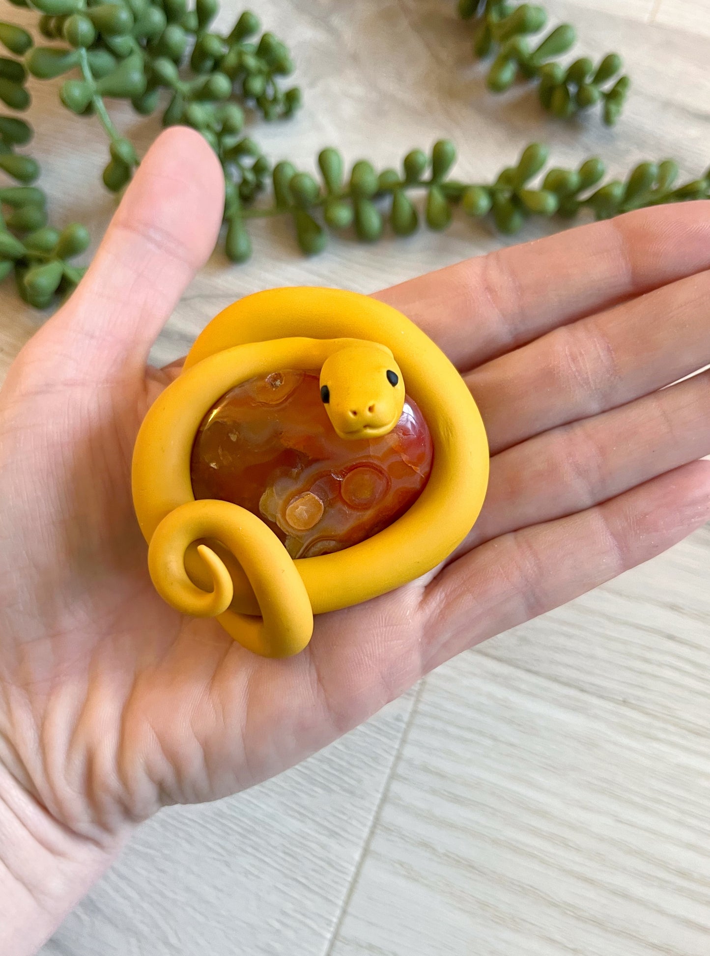 Hand Sculpted Palm Snake Guarding Carnelian Tumble